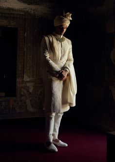 Achieve timeless sophistication in this ivory raw silk sherwani, featuring tonal dori work and highlighted with beads, pearls, and crystals. Accompanied by a cotton silk kurta and churidar, it comes with a worked stole and belt. Ivory Sherwani, Dori Work, Indian Wedding Wear, Silk Kurta, Churidar, Embroidered Silk, Wedding Wear, Raw Silk, Cotton Silk