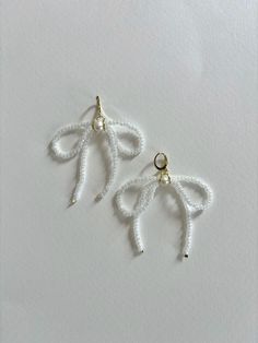 White Bow Earrings White Dangle Clip-on Pearl Earrings, White Dangle Pearl Clip-on Earrings, White Pearl Dangle Clip-on Earrings, Handmade White Dangle Clip-on Earrings, White Single Dangle Clip-on Earring, White Clip-on Drop Earrings, Adjustable White Crystal Earrings, White Crystal Drop Earrings With Ear Wire, Adjustable White Earrings For Parties