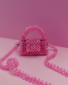 Elegant feminine mini bag perfect for sunny days and festive nights. Can be worn over the shoulder, crossbody or carried by hand. Available in a stunning range of colors. Color: Azalea Pink Materials: luminous crystals (glass) Lining: velvet Accessories: beaded shoulder strap or removable shoulder chain (gold/silver-tone metal) Dimensions: L 11,5 x H 12 x 3,5cm Jewerly Bag, Pearl Purse, Velvet Accessories, Cute Mini Bags, Hand Beaded Bag, Jeweled Bag, Crystal Bags, Bead Charms Diy, Women's Bags By Style