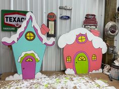 two cardboard houses sitting on top of a table