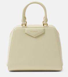 Antigona Cube Mini leather tote bag in green - Givenchy | Mytheresa Light Luxury Beige Bag With Top Carry Handle, Beige Light Luxury Bag With Top Carry Handle, Light Luxury Satchel With Top Handle, Light Luxury Satchel Shoulder Bag With Handles, Light Luxury Bag With Gold-tone Hardware And Double Handle, Light Luxury Bags With Gold-tone Hardware And Double Handle, Light Luxury Top Handle Bag With Detachable Strap, Light Luxury Beige Shoulder Bag With Top Carry Handle, Light Luxury Evening Bag With Double Handle