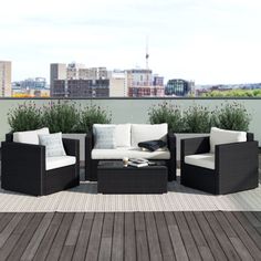 an outdoor furniture set on a deck overlooking the city