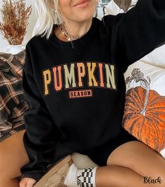 Embrace the cozy vibes of autumn with our Pumpkin Season Sweatshirt! This cute fall sweatshirt features "Pumpkin Season" emblazoned in fun fall colors, perfect for pumpkin patch outings or cozy days at home. Our pumpkin crewneck is crafted from soft, high-quality fabric that ensures warmth and comfort as the leaves change color. This adorable pumpkin sweater is a must-have addition to your autumn wardrobe, making it the ideal autumn sweatshirt for all your seasonal activities. Whether you're sea Fall Outfits With Sweatshirts, Black Fall Sweater For College, Black Letter Print Sweater For Fall, Trendy Long Sleeve Fall Sweatshirt, Casual Sweater With Graphic Print For Fall, Trendy Long Sleeve Sweatshirt For Fall, Fall Sweater With Letter Print And Long Sleeves, Letter Print Sweater For Fall Streetwear, Trendy Graphic Print Sweatshirt For Fall