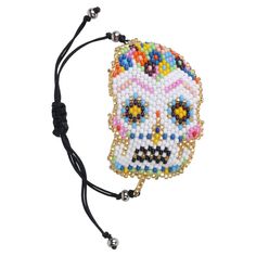 Placing a sugar skull in your home will bring you good fortune.  The traditional sugar skull plays an important role in celebrating the life of deceased loved ones. Hand beaded with love by our talented artisans, a portion of the proceeds from this collection will be donated to empower women and alleviate poverty in Guatemala.  Your purchase makes a difference! Adjustable Skull Print Bracelet As Gift, Multicolor Skull Jewelry For Day Of The Dead, Day Of The Dead Multicolor Skull Jewelry, White Skull Jewelry For Day Of The Dead, Handmade Bohemian Bracelets For Halloween, Bohemian Handmade Bracelets For Halloween, Day Of The Dead Beaded Jewelry Gift, Handmade Skull Bracelet As A Gift, Adjustable Handmade Skull Bracelets