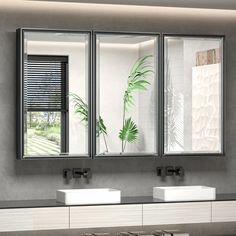 a bathroom with two sinks and three mirrors