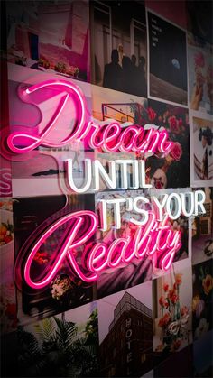 the words dream until it's your reality are lit up against a wall covered in photos