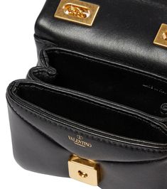 Valentino Garavani addresses your after-dark arm candy with this black crossbody bag. The design is made from padded leather with an envelope-style opening and iconic pyramidal hardware. material: lamb leather internal details: leather lining, internal slot pockets colour of fastening: antique gold chain shoulder strap Leather Crossbody Flap Bag With Gold-tone Logo, Designer Flap Bag With Gold-tone Logo Plaque, Designer Leather Flap Bag With Gold-tone Logo, Leather Clutch Bag With Gold-tone Logo Plaque, Luxury Crossbody Flap Bag With Gold-tone Logo, Luxury Evening Flap Bag With Turn-lock Closure, Luxury Evening Flap Bag With Gold-tone Logo, Evening Crossbody Flap Bag With Gold-tone Logo, Leather Crossbody Bag Small