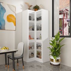 a room with a table, chairs and a potted plant in the corner next to it