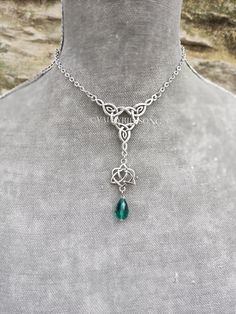 Emerald gren crystal celtic love knot choker necklace. A statement unique piece for your special day or for your everyday. I can make it in your desired length! Just tell me  PLEASE read my shop announcement before placing an order so you know what to expect right now. Plus, when ordering from outside Europe, don't forget to provide a phone number for the courier to ensure the fastest and smoothest delivery. ✨ Celtic heart knot necklace with emerald green faceted crystal drop, perfect for a celt Green Crystal Clavicle Chain Necklace, Silver Emerald Pendant Necklace With Clavicle Chain, Green Gothic Necklace, Celtic Emerald Necklace, Crystal Forest, Celtic Heart Knot, Green Pendant Crystal Amulet Necklace, Choker Necklace Silver, Celtic Love Knot