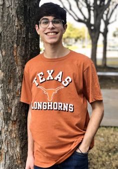 Support your Texas Longhorns in this Burnt Orange Short Sleeve Fashion Tee! This Number One Distressed Fashion T Shirt features a distressed screen print of "Texas" Longhorns logo and "Longhorns". Be ready to shout "Hook Em Horns" when you wear this Texas Short Sleeve Fashion T Shirt in the stadium or on the street. Short Sleeve, Crew Neck, Team Graphic, Majestic Branding Logo, Unisex, Fit: True to Size, 100% Cotton, Machine Washable Brown Crew Neck Top For College, Casual Orange College Tops, Casual Orange Tops For College, Distressed Crew Neck Tops For College, Collegiate Short Sleeve T-shirt For Fall, Collegiate Short Sleeve Tops For Fall, Brown Distressed Crew Neck Top, Casual Tri-blend Distressed Tops, Casual Orange T-shirt For College