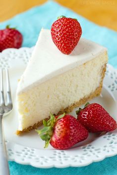 a slice of cheesecake on a plate with strawberries