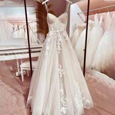 a white wedding dress on display in a store