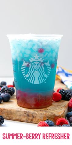 a drink with berries and blueberries in it on a cutting board next to the words summer - berry refresher