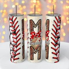 three personalized tumblers with baseballs and bows on them are sitting on a table