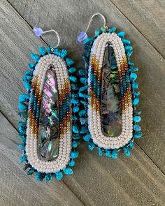 Abalone middle inlays, size 11 Czech beads, turquoise chip beads(edging of earrings) and on hypoallergenic silver hooks. Abalone Beaded Earrings, Artisan Beaded Heishi Beads Earrings, Artisan Beaded Earrings With Heishi Beads, Unique Turquoise Beaded Earrings, Handmade Blue Heishi Beads Earrings, Southwestern Turquoise Beaded Earrings, Southwestern Turquoise Earrings With Colorful Beads, Artisan Turquoise Earrings For Beach, Southwestern Style Turquoise Beaded Earrings