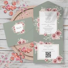 wedding stationery with pink flowers and greenery on the front, along with matching envelopes