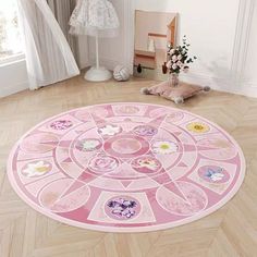 a pink circular rug with flowers on it