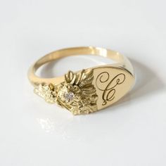 This vintage-inspired floral ring is a row of dainty flowers wrapped around your fingers. Handmade and polished, it is available in solid 8K and 14K gold. This item is engravable with text or monogram of your choice at no extra cost. The initals are engraved onto the ring and embedded in the 3D model for a flawless embossed finish. It is also possible to add a diamond or birthstone or diamond to this ring at an additional fee. Please inquire for details. A few notes about our gold:- Though we do Ladies Signet Ring, Elegant 14k Stamped Cluster Ring For Promise, Yellow Gold Flower Ring With 17 Jewels For Anniversary, Heirloom Style Rose Gold Cluster Ring, Vintage Diamond Signet Wedding Ring, Vintage Diamond Signet Ring For Wedding, Classic Yellow Gold Flower Promise Ring, Classic 14k Gold Round Flower Ring, Classic Round Flower Ring In 14k Gold