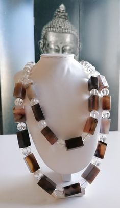 Handmade 2-row statement necklace made of agate and rock crystal. The agate blocks are approx. 22 mm x 12 mm x 12 mm in brown. The faceted rock crystal beads are approx. 12 mm. The length is approx. 49.5 cm plus approx. 4 cm heart clasp. The extension chain is approx. 4 cm. Available immediately. The chain clasp and the extension chain are silver. The color, size and shape of the beads may vary. The colors of the beads may vary depending on camera and monitor settings. Combined shipping possible Brown Pearls, Rock Crystal Necklace, Handmade Gemstone Jewelry, Gemstone Jewelry Handmade, Necklace Statement, Agate Necklace, Rock Crystal, Bridesmaids Gifts, Necklace Handmade