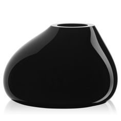 a black vase sitting on top of a white table