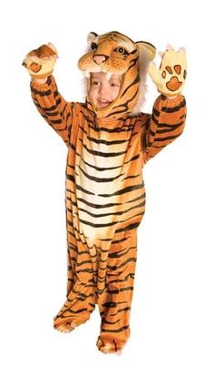 a child in a tiger costume is standing with his hands up to the side,