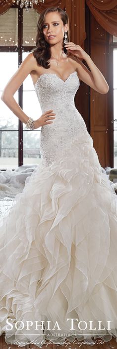 a woman in a wedding dress posing for the camera