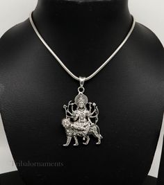 Divine 92.5 sterling silver Indian Hindu Idols Blessing Goddess Bhawani/Durga/Santoshi maa with lion vintage antique style stunning divine pendant, best gifting unisex jewelry from India. Metal-925 sterling silver. Item type-Pendant/ Locket Weight-17.910 grams. Height-5.9 centimeter. Width-3.5 centimeters. Stamped-925. Finish-Oxidized. note :chain is not include in this price, to purchase chain please visit following links: https://www.etsy.com/listing/823425858/16-to-30-long-screw-chain-925-ste Heavy Jewelry Gift For Navratri, Silver Oxidized Finish Snake Chain Jewelry, Silver Oxidized Snake Chain Jewelry, Spiritual Pendant Jewelry For Puja, Silver Snake Chain Jewelry With Oxidized Finish, Hallmarked Spiritual Necklaces For Festivals, Spiritual Locket Jewelry For Festive Occasions, Sterling Silver Necklace For Puja And Festivals, Sterling Silver Pendant Necklace For Diwali