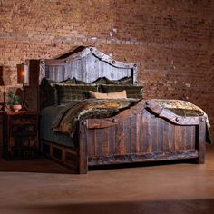 a bedroom with brick walls and an old wooden bed in the middle is furnished with rustic furniture