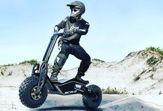 a man riding an electric scooter in the sand