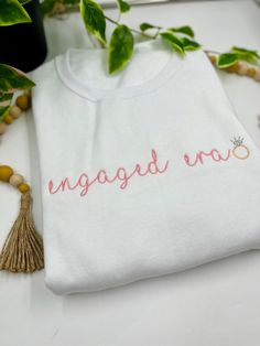 girlieeeeee. congrats!!! You're finally in your engaged era!! I'm so happy for you! This is a white jerzees traditional sweatshirt with a beautiful classic pink thread featuring an adorable engaged era design! The diamond ring is so cute, and I love the custom touch with the initials on the sleeve! Make sure to select your thread color for the design. This will effect the "engaged era" text only! Pictured here is the perfect pink thread color. Make sure to type in your initials in the custom tex Pink Thread, Perfect Pink, Comfort Color, So Happy, Tshirt Colors, So Cute, Diamond Ring, Initials, Thread