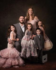 a family posing for a photo in formal wear