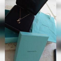 Authentic Tiffany & Co. Peretti 18k Gold Initial Letter "B" Pendant Necklace 16". Alphabet Accessory Brand Tiffany & Co. 100% Authentic 18 K Rose Gold Size About Chain 41 Cm Top 1 X 2.6 Cm Material 18k Accessories Preservation Box, Blue Tiffany & Co Box And Gift Bag. The Blue Box Is In Pretty Good Condition But The Gift Bag Has Some Stains, Ripped And Shows Signs Of Handling. Please See Pictures. Letter Necklace Gold Tiffany & Co., Letter Pendant Necklace Tiffany & Co., Designer Yellow Gold Evening Necklace, Designer Yellow Gold Necklaces For Evening, Designer Yellow Gold Necklace For Evening, Luxury Formal 14k Stamped Necklaces, Designer Gold Necklaces For Anniversary, Designer Yellow Gold Necklace For Anniversary, Elegant Formal Necklace With Initial Pendant