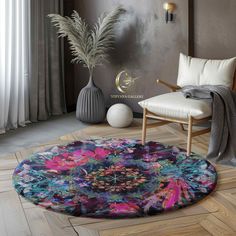 a round rug with an abstract design on the floor next to a chair and potted plant