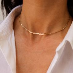 Our 14K Yellow Gold Figaro Chain Choker is the perfect chunky layering choker to add to your neck stack. In Solid Gold, it's a substantial chain that will last you a lifetime. Gold KT: 14K Solid Gold Gold Color: Yellow Gold Choker Length: 14" or 15" Chain Width: 3mm Chain Style: Italian Figaro Chain Clasp Closure: Lobster Claw Everyday Yellow Gold Choker With Gold Chain, Chic Yellow Gold Figaro Chain Necklace, Everyday Gold Chain Choker, Dainty Gold Chain Choker, Figaro Chain Choker Necklace As Gift, Figaro Chain Choker Jewelry As Gift, Figaro Chain Choker Jewelry For Gift, Minimalist Figaro Chain Choker Necklace, Figaro Chain Choker Necklace For Gifts