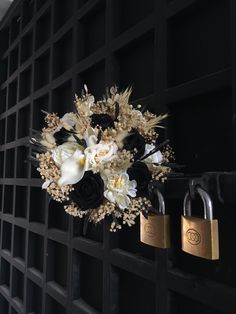 a bunch of flowers that are sitting on a doorknob with padlocks