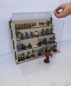 a display case with toy army figures and toys on it's sides, in front of a white background