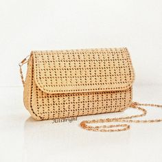 This small straw bag is a handmade evening clutch for women for any occasion: holiday, evening, wedding, going out. The natural straw bag will make you image complete. The mini shoulder purse is handmade using the technique of weaving on plastic canvas. It has a tight frame, keeps its shape well. SIZE: - SMALL - length 18cm/7 in, height 11cm/4 in, width 5.5cm/2 in - MEDIUM - length 23cm/9 in, height 14cm/5.5 in, width 6cm/2.3 in - LARGE - length 27cm/10.5 in, height 16.5cm/6.5 in, width 6.5cm/2.5 in DETAILS: - thread is 100% raffia - removable chain handle: 118cm/46 in - color - beige - 100% silk lining (sewn by an invisible stitch manually) with inside pocket - magnetic button - item comes in a packing bag. NOTE! The lining pattern and chain pattern may differ from photo. Washing instruct Elegant Woven Natural Straw Bag, Elegant Natural Woven Straw Bag, Elegant Straw Beach Bag, Elegant Beige Straw Shoulder Bag, Elegant Natural Straw Bag, Summer Party Woven Shoulder Bag, Elegant Woven Crochet Bag In Natural Color, Summer Gold Clutch For Everyday Use, Elegant Summer Woven Crochet Bag