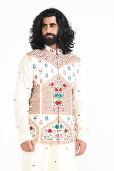 Ivory floral hand embroidered nehru jacket with intricate details on Linen Satin. Paired with Ivory slim fit Pant Pajama. Color of the actual garment may vary due to lighting conditions during the shoot.

Size Chart For Men





	
	
					Men's Size Chart
		

		
		
						
				Size Chart For Men
				Custom Size Measurement Guide
			
			
				
				
				Custom Size Measurement Guide
1. Take your measurements at ease…don’t hold your breath!
2. Be a little generous with the measurements. It’s always ea Festive Off-white Bandhgala With Intricate Embroidery, Anarkali Style Floral Embroidered Sherwani For Wedding, Anarkali Style Wedding Sherwani With Floral Embroidery, Wedding Anarkali Sherwani With Floral Embroidery, Bollywood Style Off White Bandhgala For Festive Occasions, Bollywood Style Off-white Bandhgala For Festive Occasions, Off White Bollywood Bandhgala For Festive Occasions, Cream Nehru Jacket With Zari Work Long Sleeve, Ceremonial Cream Nehru Jacket With Intricate Embroidery