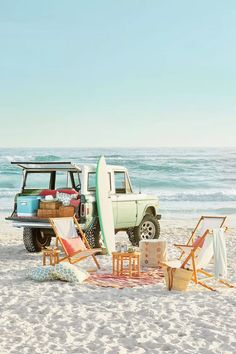 an advertisement for the coast living magazine features surfboards and chairs on the beach, while a truck is parked in the background