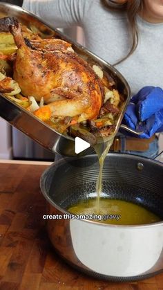 a woman pouring gravy onto a turkey in a pan