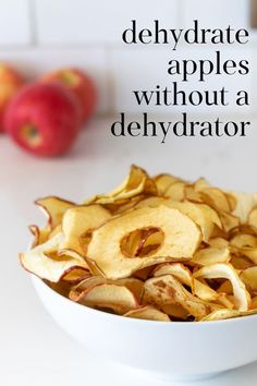 a bowl filled with sliced apples on top of a table