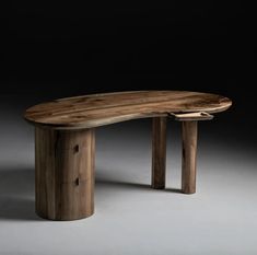 an oval wooden table with two legs and one end cut out to show the shape