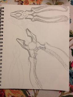 a drawing of a pair of scissor's on top of a notebook