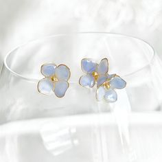 Blue Hydrangeas Flower Mismatch Stud Earrings These Blue Hydrangeas Flower Mismatch Stud Earrings are handmade and the perfect accessory for any summer outfit. With the unique design, these earrings make for a great gift, too! As a gift shop, we offer a complimentary gift box for every order. Some details - Size of flower: around 12mm*20mm Material Ear studs: sterling silver Flowers: resin The Blue Hydrangeas Flower Mismatch Stud Earrings are sold in pair of two earrings. About postage: Standard postage When choosing standard postage, we assume this order is for yourself, or you will wrap the item yourself before giving it out as a gift (the complimentary gift box would be posted flat with your order under standard postage). Hence, to be environmentally friendly and to reduce postage costs Affordable Blue Flower Charm Earrings, Cheap Blue Flower-shaped Jewelry, Summer Light Blue Pierced Earrings, Blue Flower Shaped Earrings For Summer, Blue Flower-shaped Summer Earrings, Blue Earrings With Flower Charm For Spring, Spring Blue Flower Earrings, Blue Flower Charm Earrings For Spring, Blue Flower Earrings For Spring