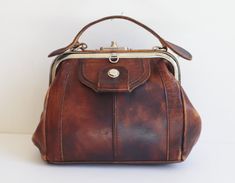 Height  18 cm - 7,08" Width  21 cm - 8,26" Depth  10,5 cm - 4,13" Shoulder strap  78 cm - 30,70" 1 big compartment and 2 smaller ones (1 with zipper) Lined Very good vintage condition BOX55 Vintage Satchel With Metal Hardware, Vintage Shoulder Bag With Metal Hardware, Vintage Office Shoulder Bag With Metal Hardware, Vintage Shoulder Bag With Metal Hardware For Office, Vintage Satchel With Metal Hardware For Everyday, Vintage Everyday Satchel With Metal Hardware, Vintage Crossbody Bag With Metal Hardware, Vintage Satchel Shoulder Bag With Metal Hardware, Vintage Shoulder Bag With Metal Hardware For Everyday