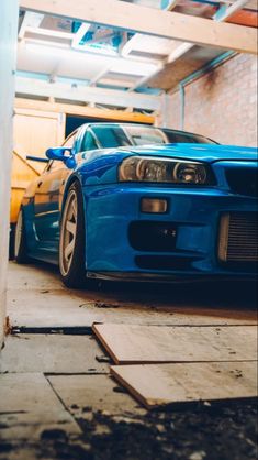 a blue sports car parked in a garage