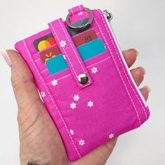 This hot pink with white stars Mini Card, Cash, and Coin Wallet features three dedicated card slots on the front secured with a snap tab, a clear pocket on the back also secured with a snap, perfect for ID, a scan card, showing off your kiddos [or grand kiddos etc., and a zippered pouch in between for stowing more cards, cash, or coins. This itty bitty wallet fits in the palm of your hand and right in your back pocket or just toss into your small or large bag!  Each dedicated card slot on the front easily accommodates 2 cards. Wallet, if used only as a card wallet, holds about 15 cards.  📬 READY TO SHIP 📝 ITEM FEATURES 📝 📏 Wallet Measures: 4.75" wide by 3.5" tall 3 Credit Card Slots   1 Clear ID Pocket Zippered Pouch 1 Split Ring   100% Cotton  MORE HERE WE GO MINI WALLETS: https://www Pocket Wallet, Coin Wallet, Mini Wallet, Pink Mini, Minimalist Wallet, Clip Wallet, Credit Card Holder, Large Bag, Money Clip Wallet