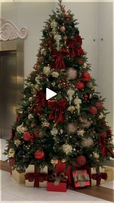 a decorated christmas tree with red and white ornaments in the center is surrounded by presents