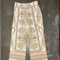 Zara Light Tan Beige Pants With Light Blue, Yellow, Burnt Orange, Khaki Green Paisley Print Pattern. Wide Leg, Side Zipper. New With Tags Ladies Xs Measures 14.5 Inches Across Waist 11 Inches Across Pant Bottom 29 Inch Inseam 40.5 Inches Top To Bottom Length Material 55% Linen, 45% Cotton Summer Wide-leg Paisley Print Pants, Chic Patterned Bottoms With Floral Print, Spring Patterned Wide Leg Printed Pants, Chic Floral Print Patterned Bottoms, Spring Patterned Stretch Bottoms, Wide Leg Bottoms With Paisley Print And Stretch, Stretch Wide Leg Bottoms With Paisley Print, Bohemian White Printed Bottoms, Wide Leg Bottoms With Paisley Print For Summer