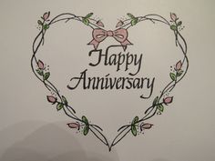 a happy anniversary card with a heart shaped frame and flowers in the shape of a bow